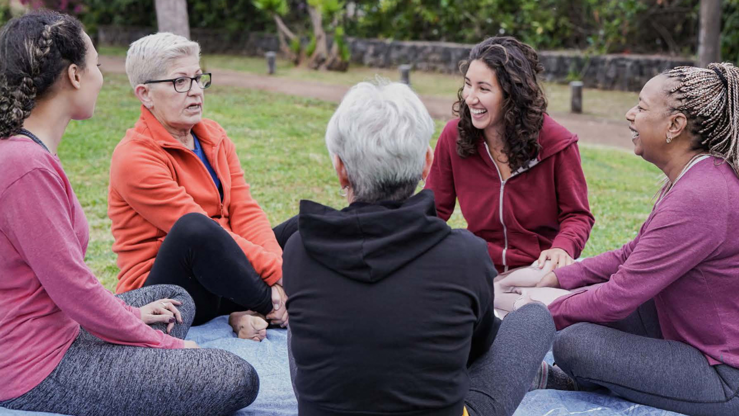 Women siting in circle in park