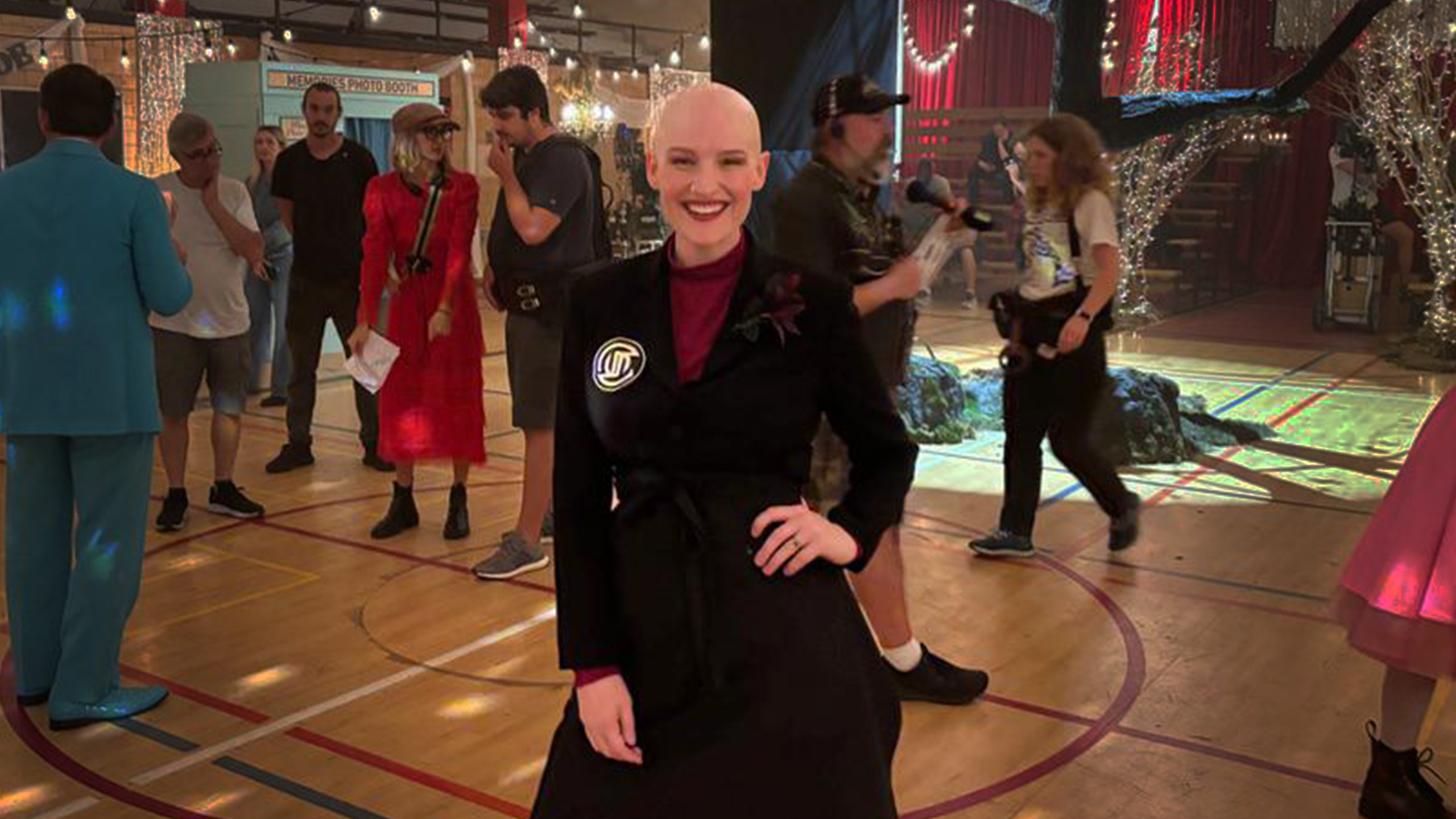 Woman in costume stands in the middle of a gymnasium