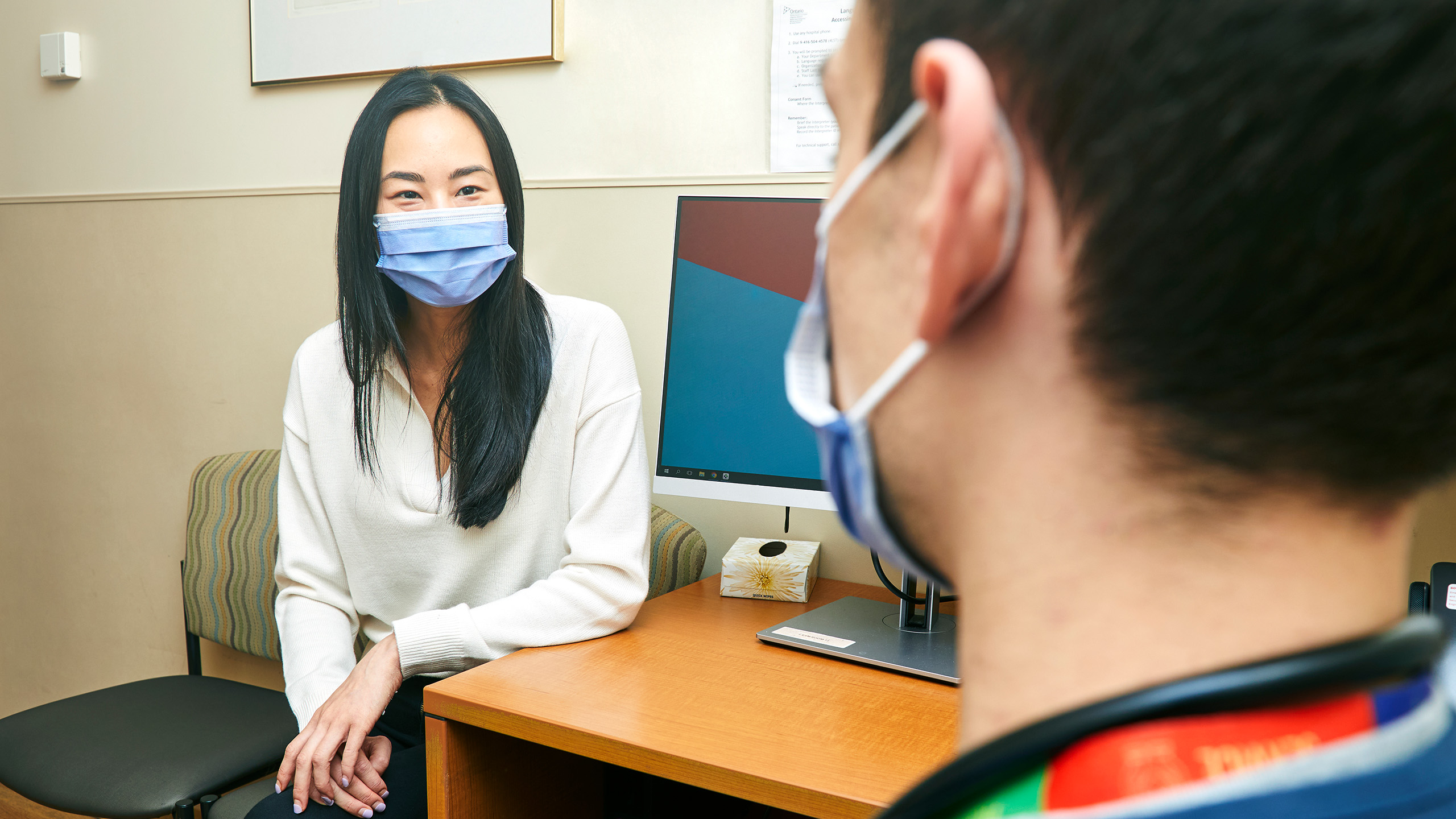woman in mask in office