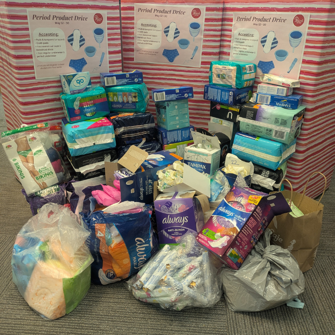 Pile of packaged products including tampons and pads.