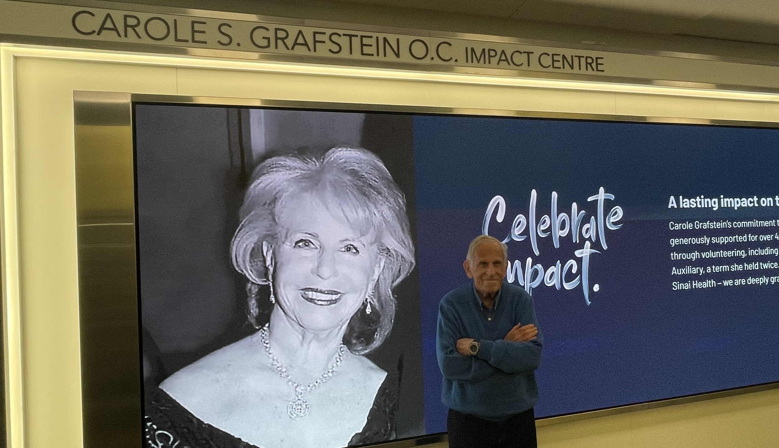 man standing in front of digital wall with displaying photo of woman