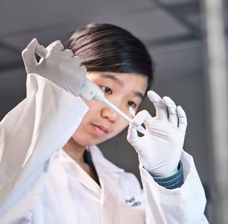 Cover of the research strategy document. A researcher in a lab.