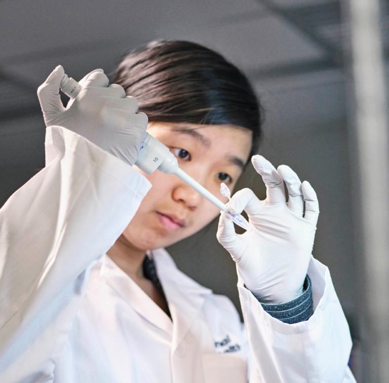 Cover of the research strategy document. A researcher in a lab.