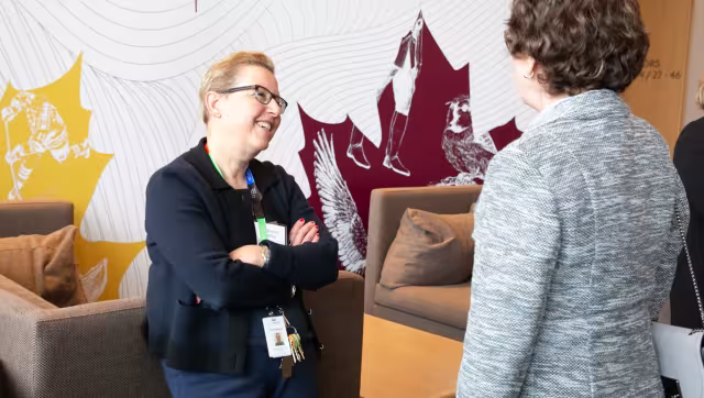 Dr. Maureen Shandling talking with a colleague.