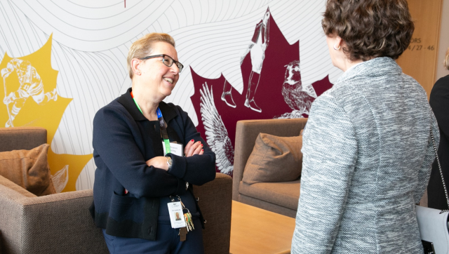 Dr. Maureen Shandling talking with a colleague.