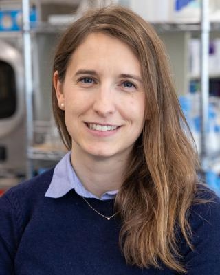 Dr. Diane Haakonsen smiling in a dark blue shirt with light blue collar.