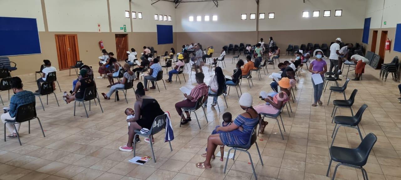 People sitting sprad out due to covid measures at the research study recruitment centre in Soweto, South Africa