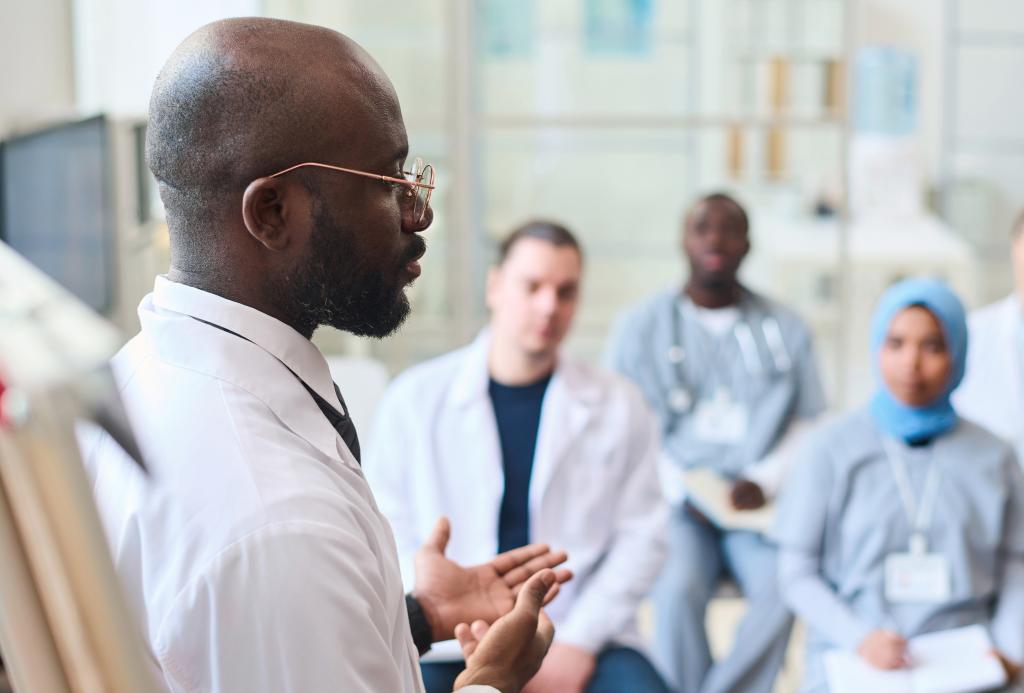 A physician presents a case to four other health-care providers