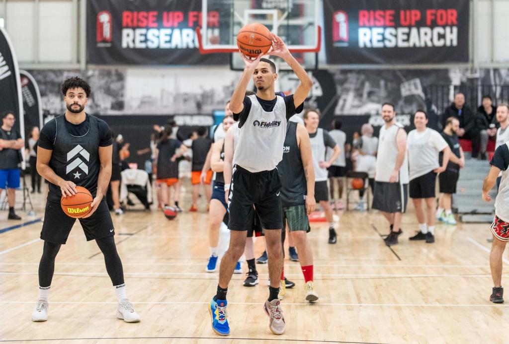 Man shooting a basketball surrounded by other players