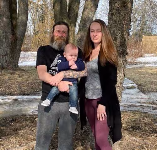 Jacquie Rombough with her partner and baby