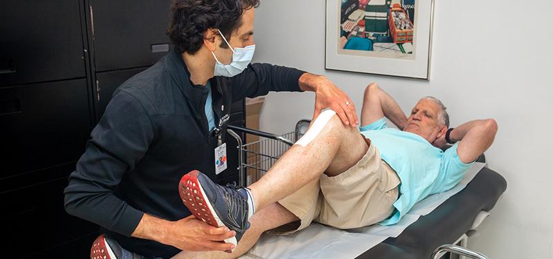 Dr. Jesse Wolfstadt, Orthopaedic Surgeon examines Gary Sandor
