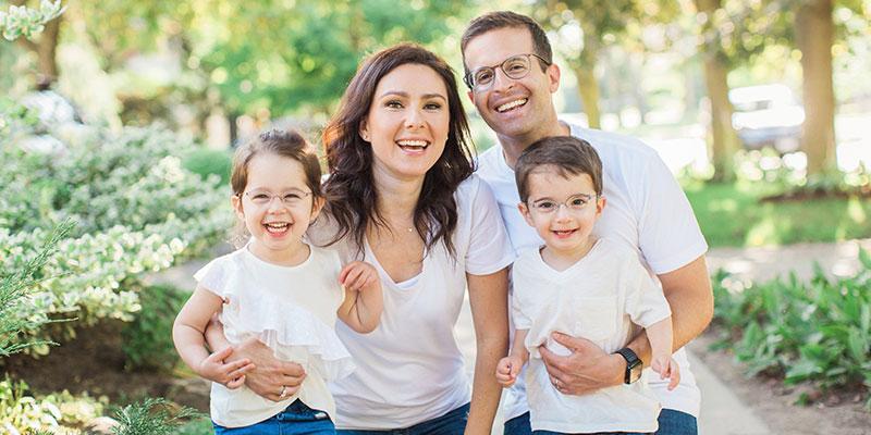 family of four standing outside