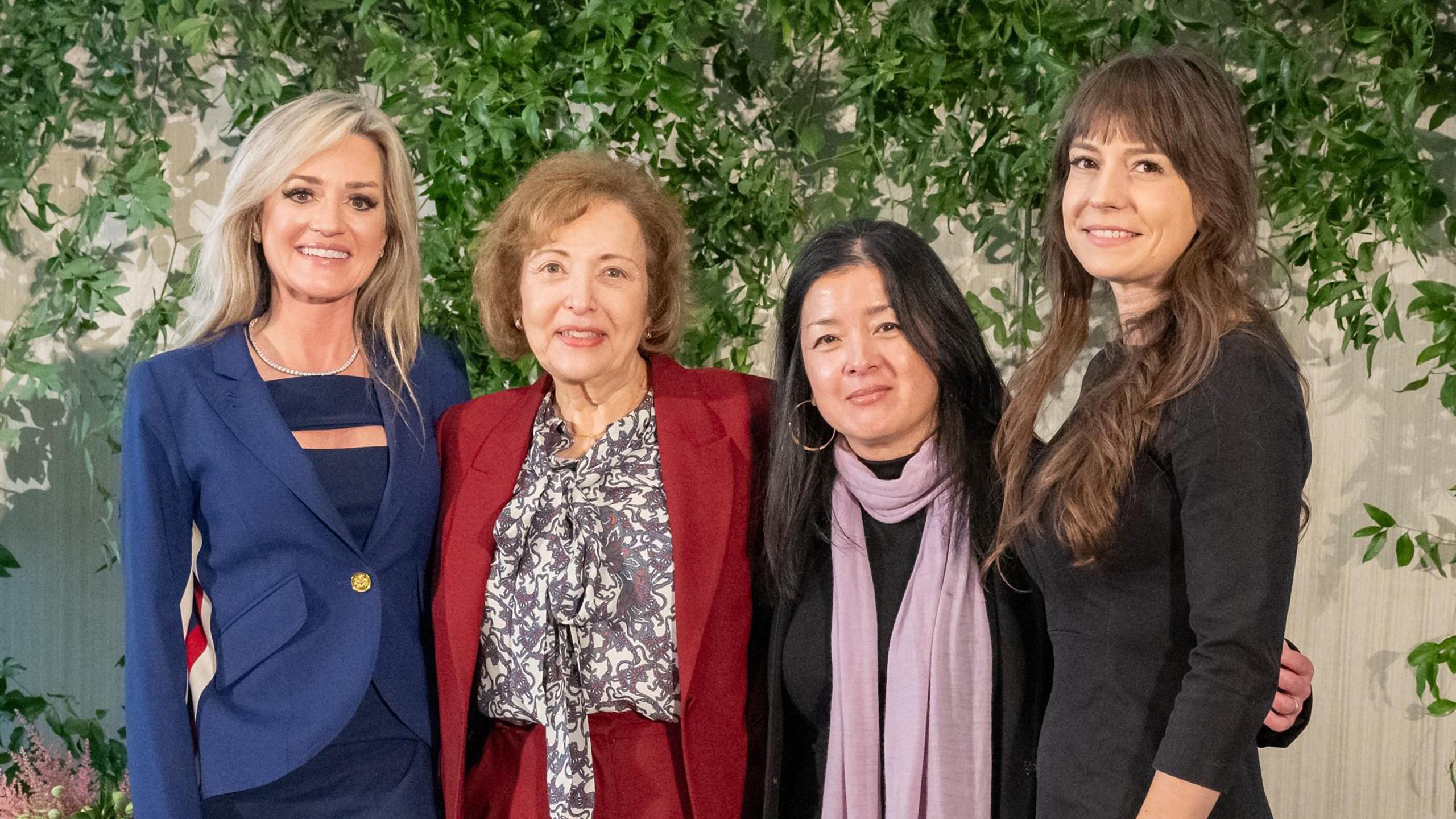 four women smiling