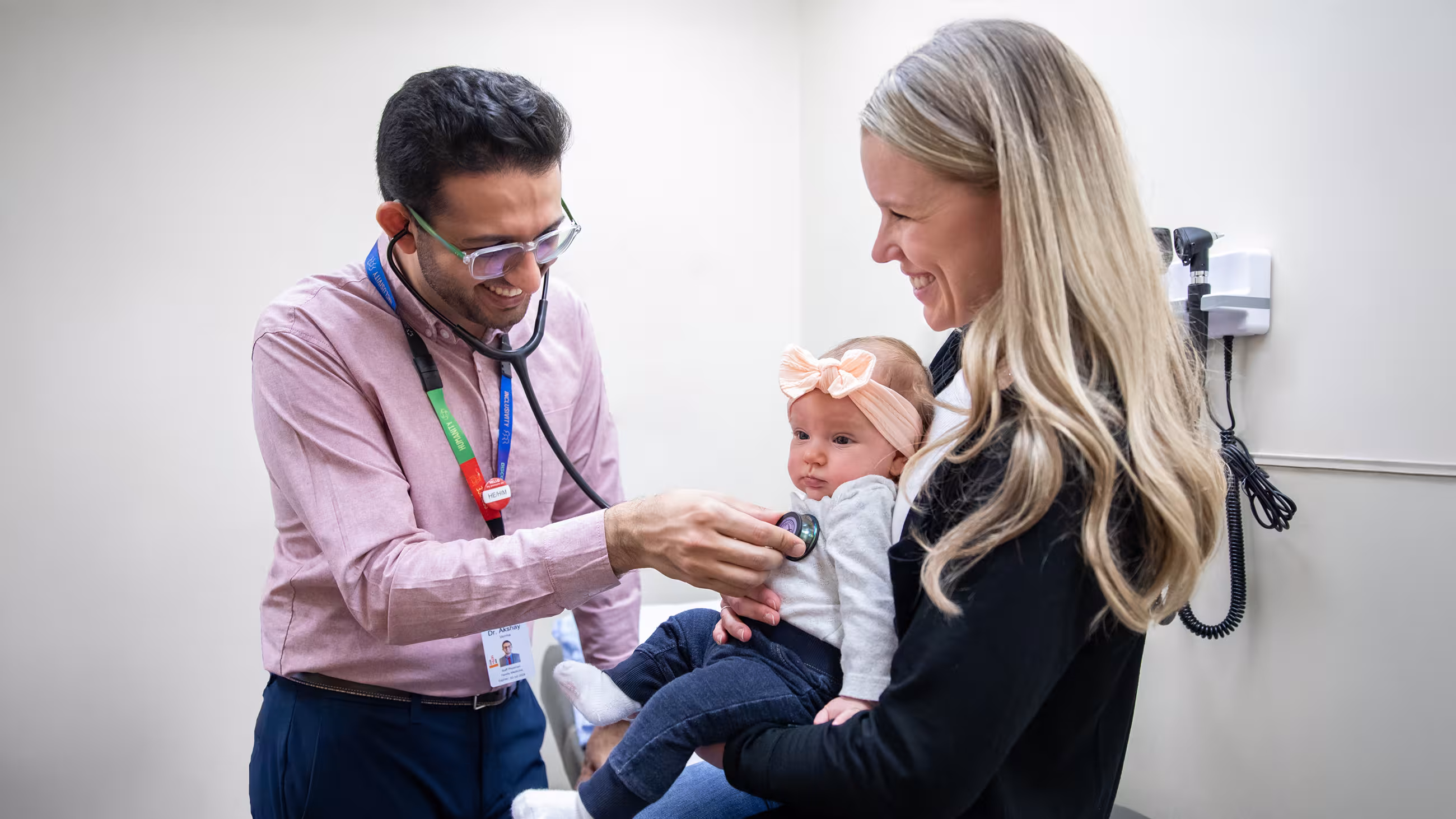 Family health physician uses a stethoscope at a patient appointment