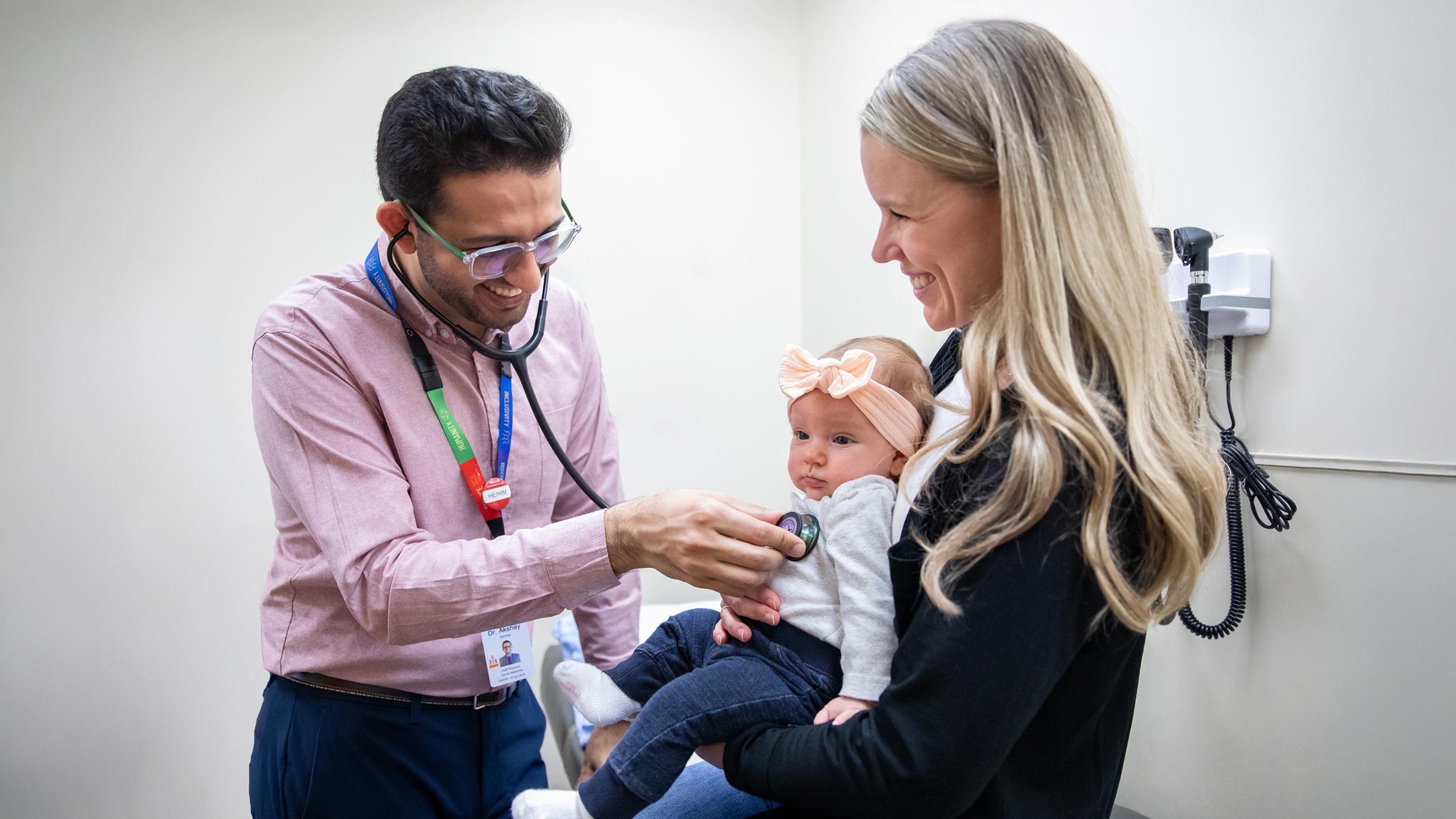 Family health physician uses a stethoscope at a patient appointment