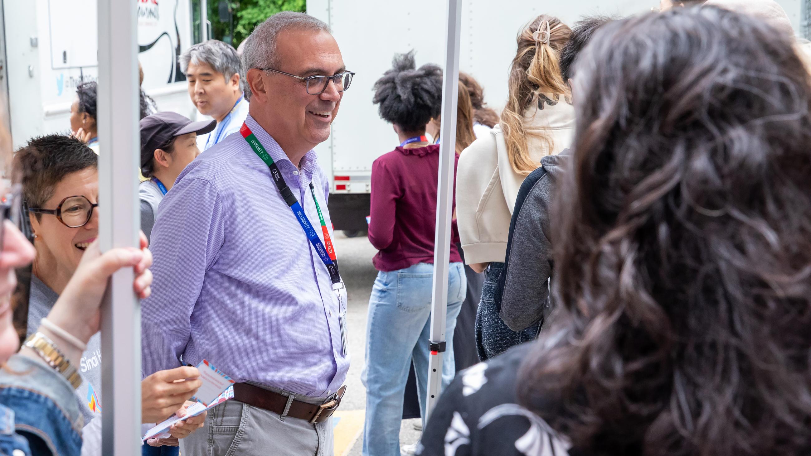 Sinai Health’s President and CEO greeting guests as they arrive at the barbeque. 