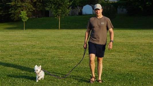 man in field with dog