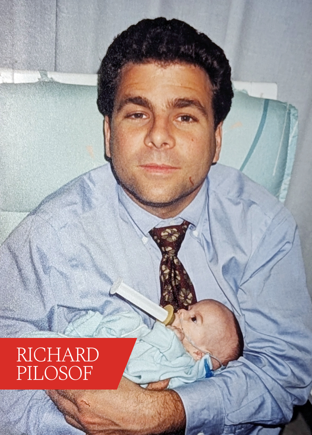 Man holds infant. Red text box reads 'Richard Pilosof'