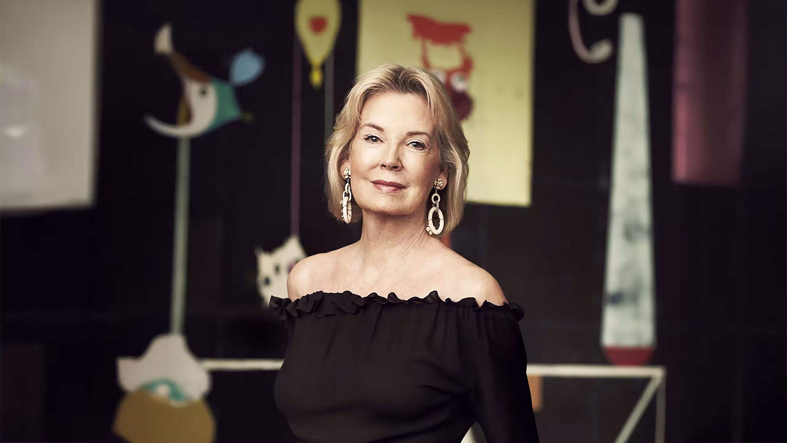 Photo of Hilary Weston wearing a black shirt in front of art sculptures