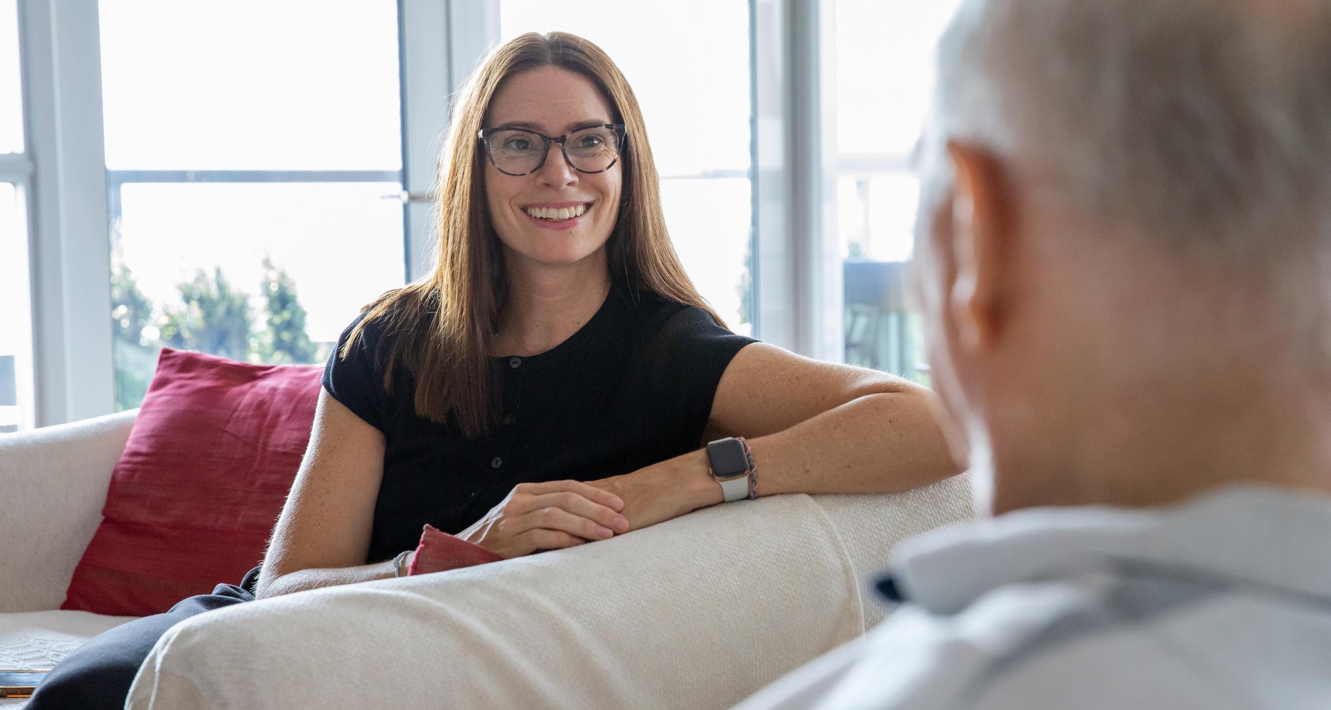 Dr. Marnie Howe sits with a patient during an at home palliative care visit.