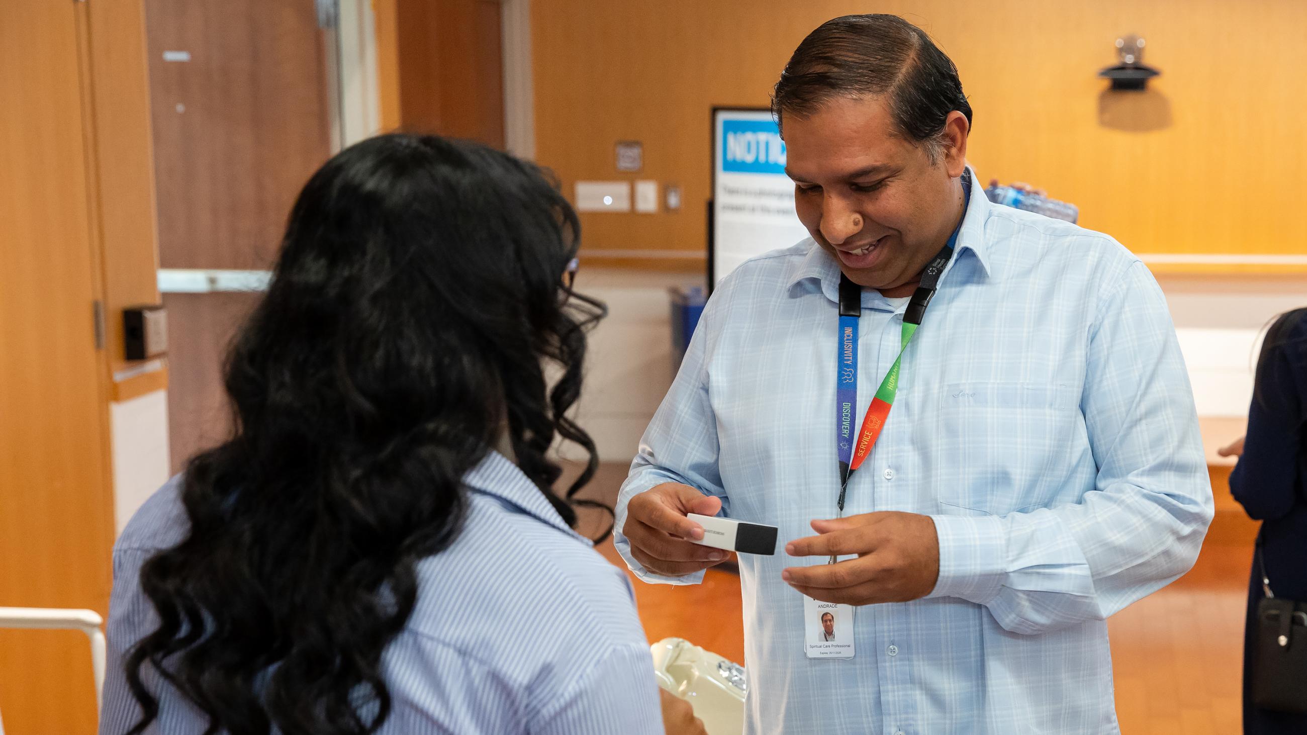 Service milestone recipient smiling as they receive a bon bon gift.