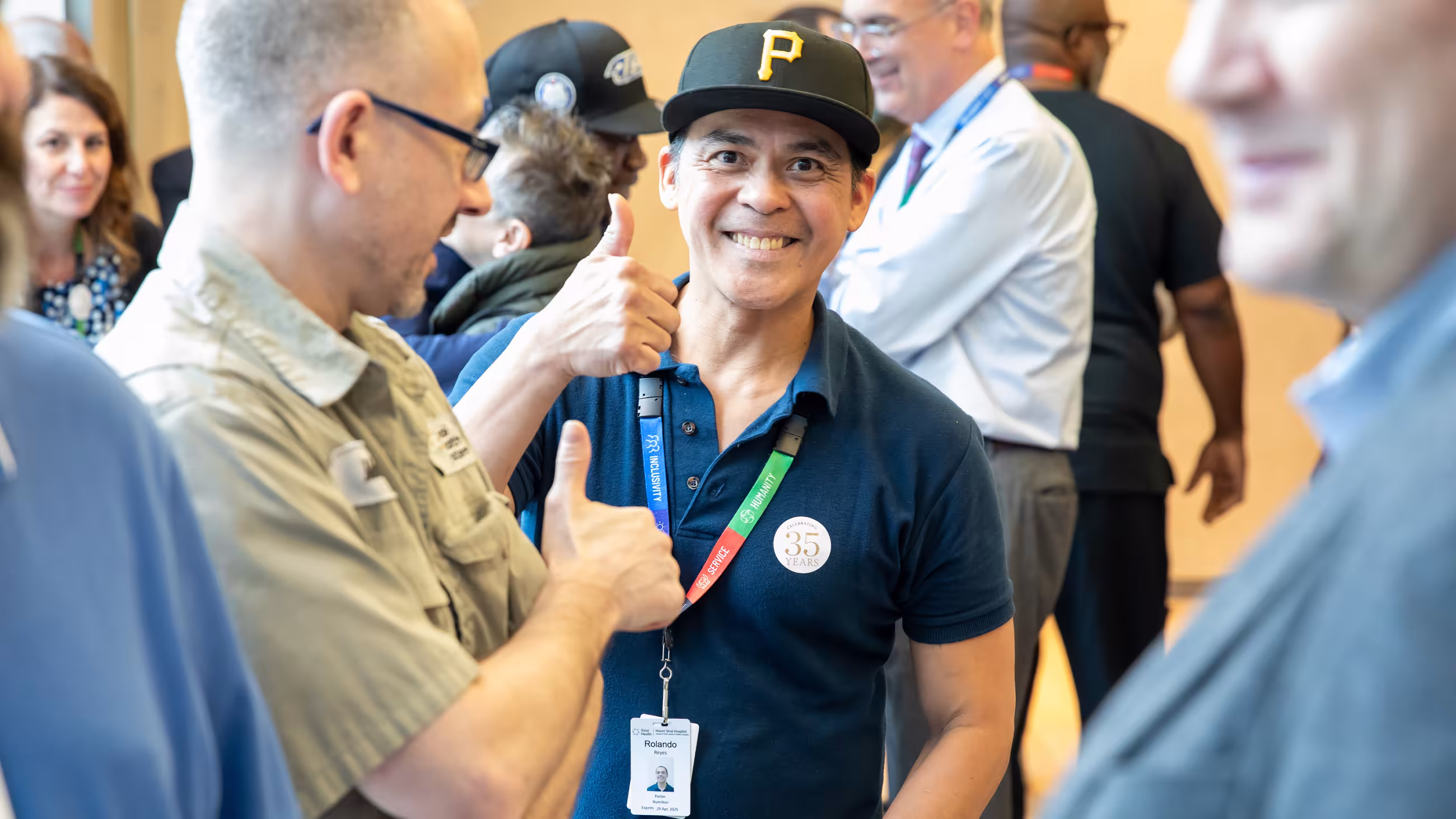 Service milestone recipient smiling and giving a thumbs up during the celebration.
