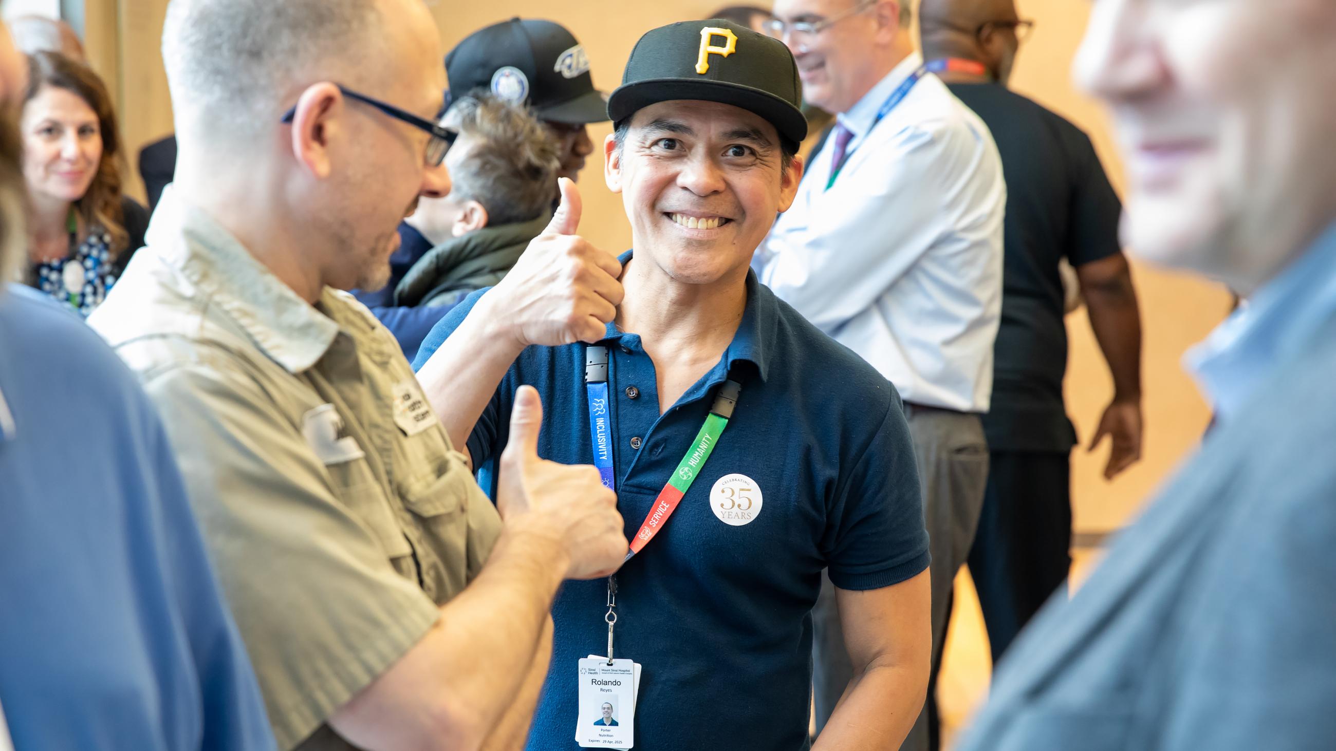 Service milestone recipient smiling and giving a thumbs up during the celebration.