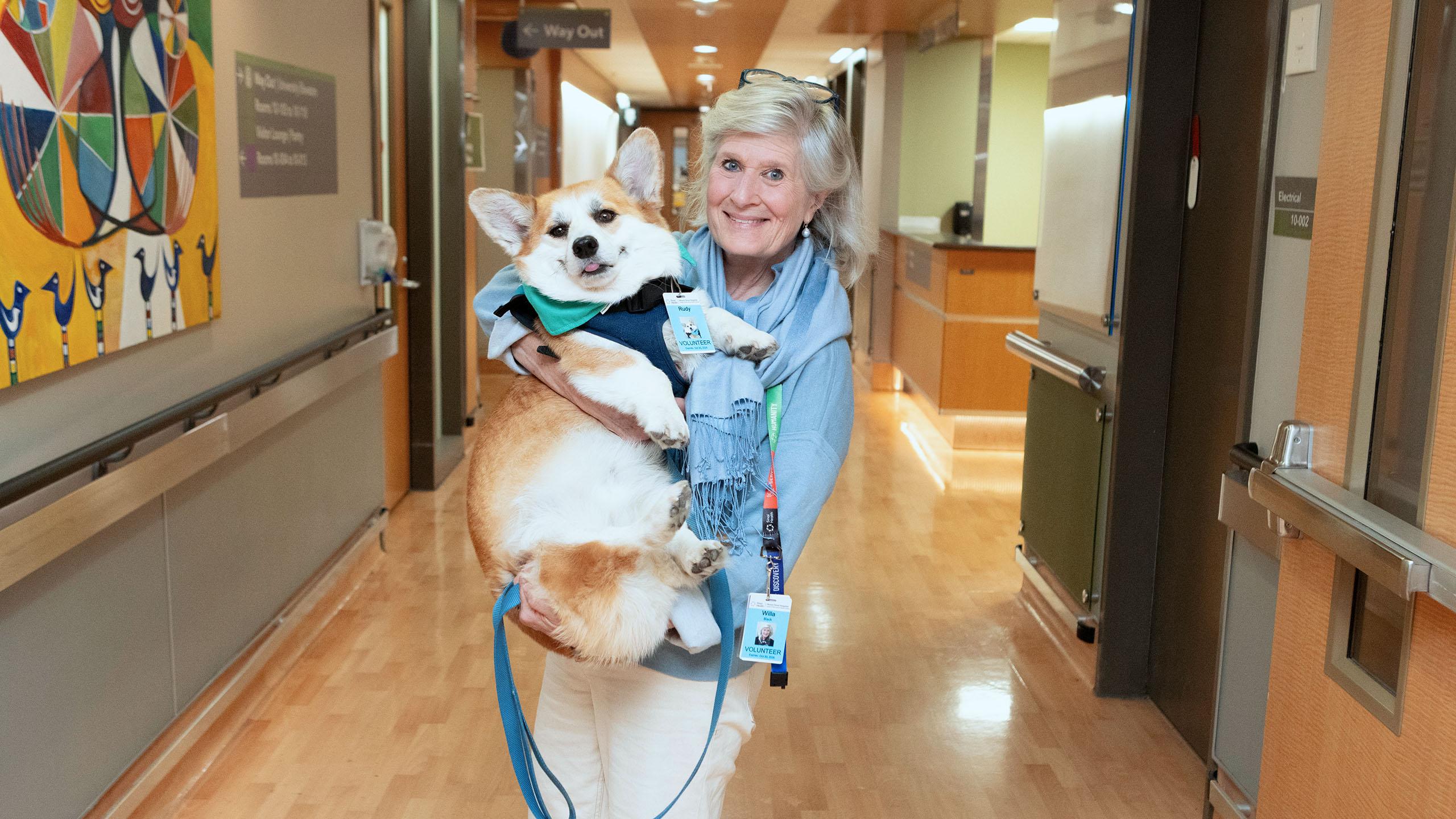 Woman holding corgi