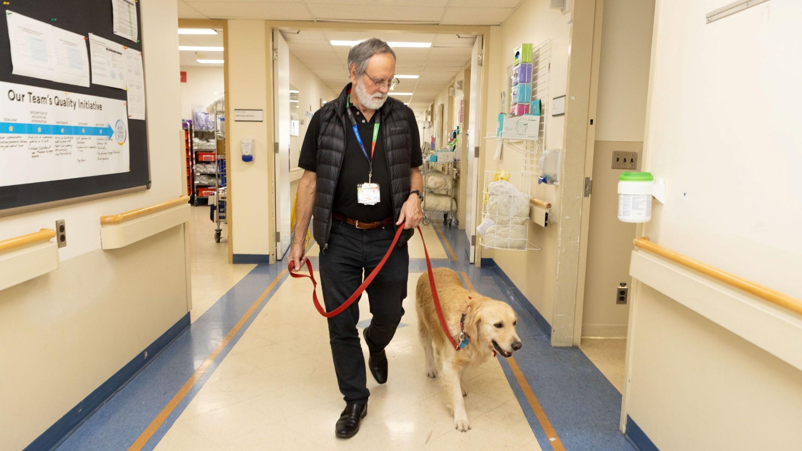 man with golden retriever