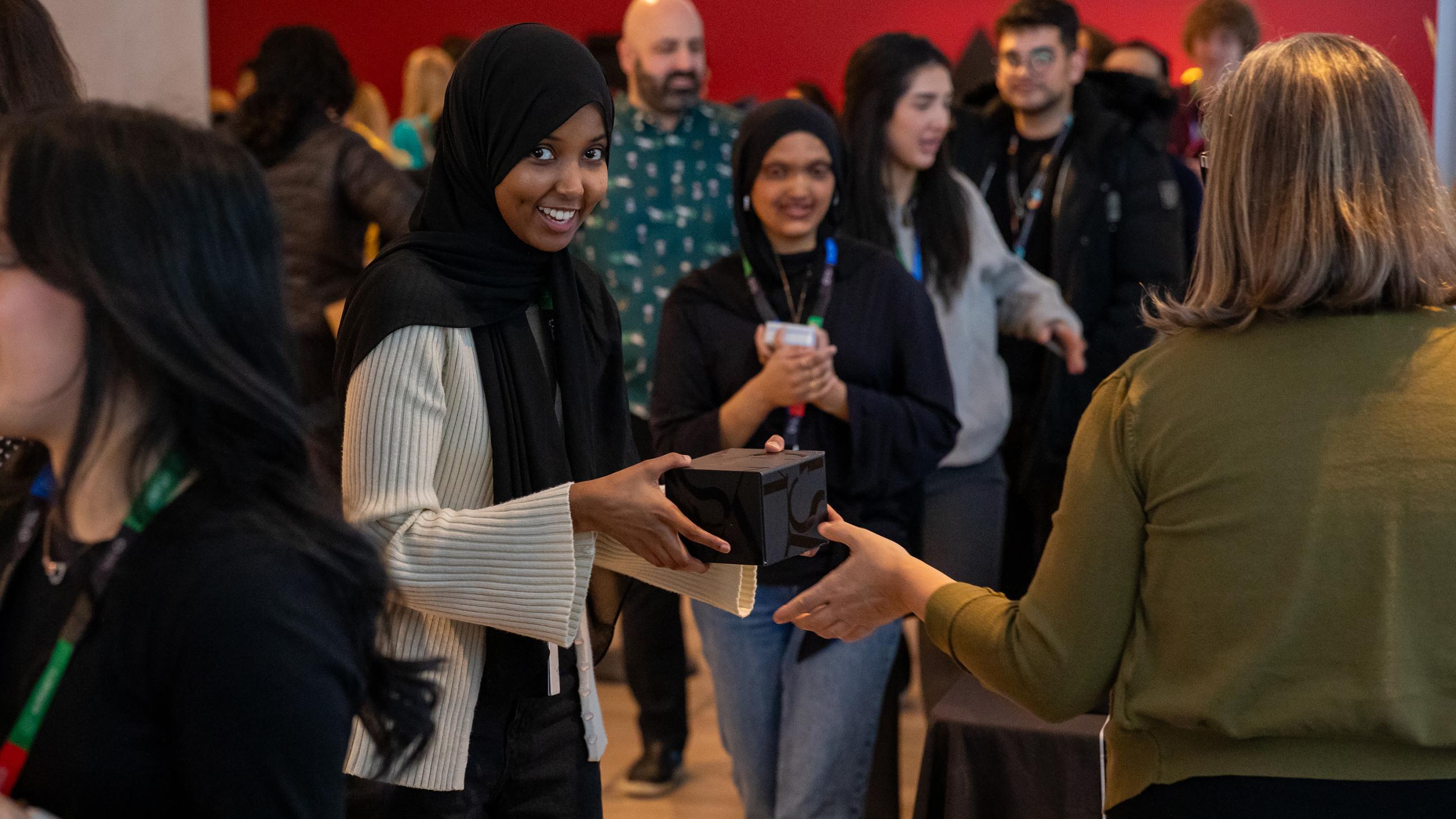 A staff member receives a holiday treat at Sinai Health’s Holiday Open House.