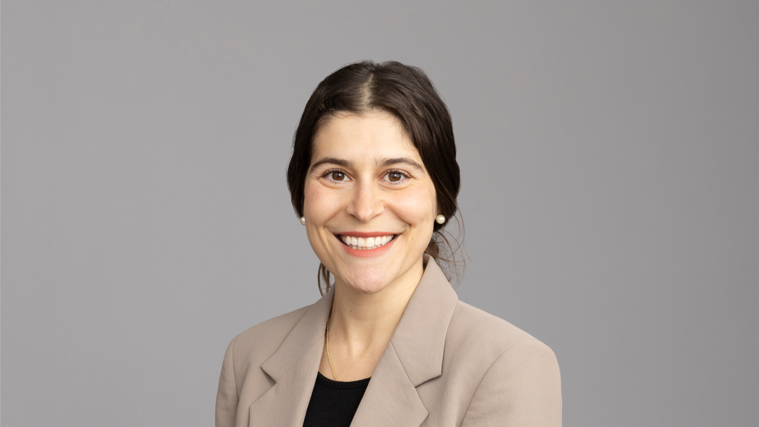 smiling woman in beige blazer
