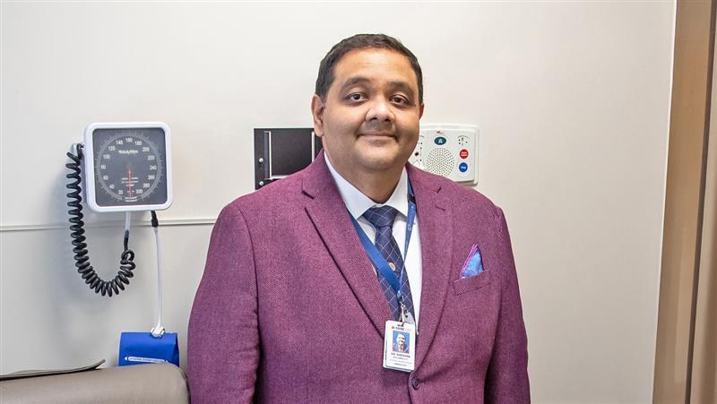 Dr. Darshan Brahmbhatt stands in exam room