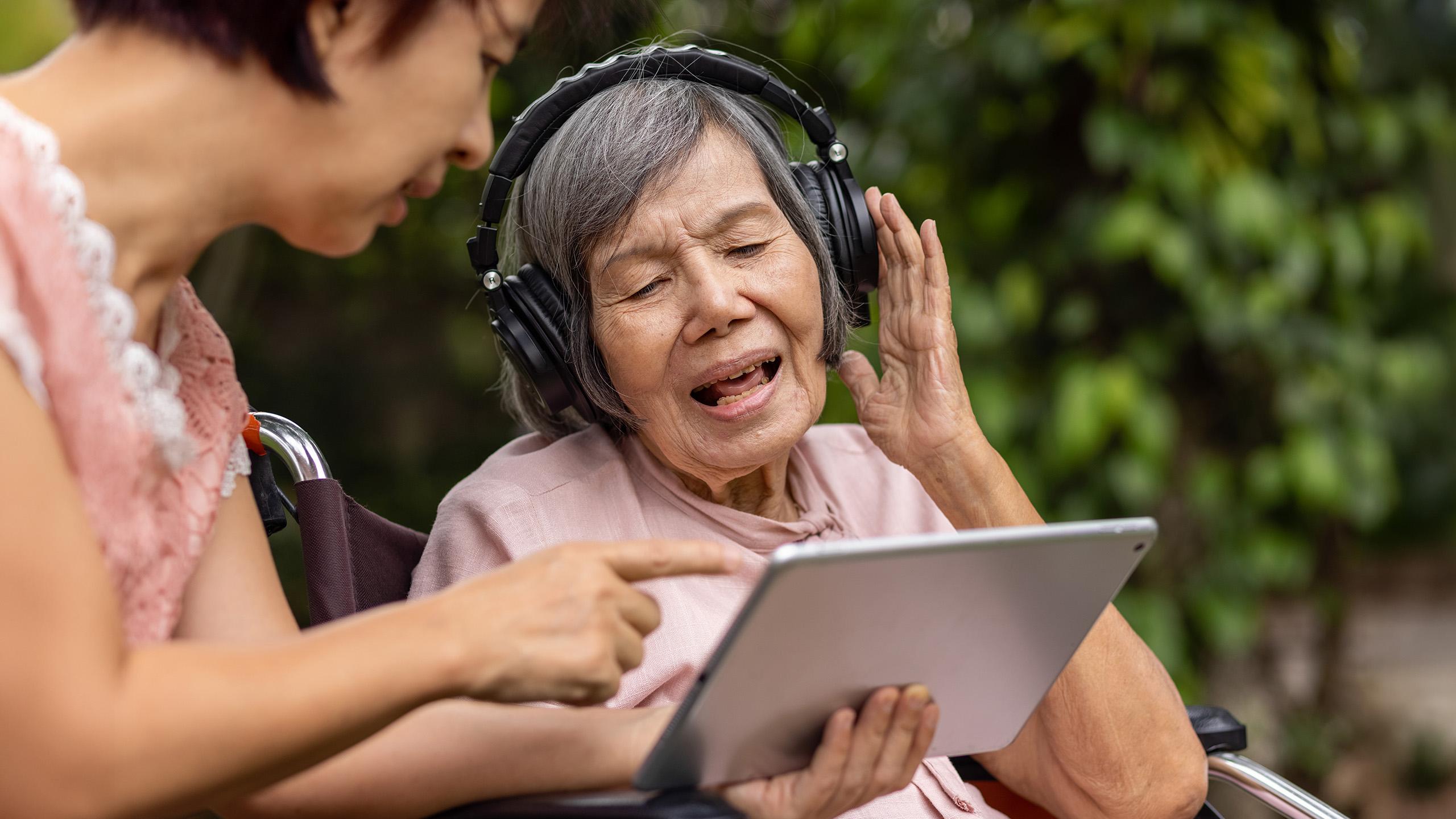 older woman wearing headphones singing