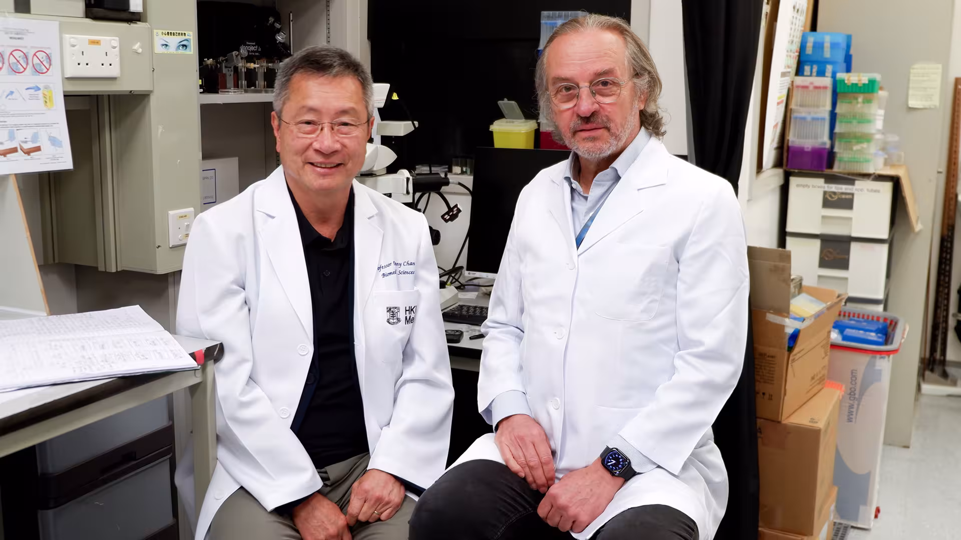 Drs. Danny Chan and Andras Nagy sit in the laboratory at Hong Kong University. 