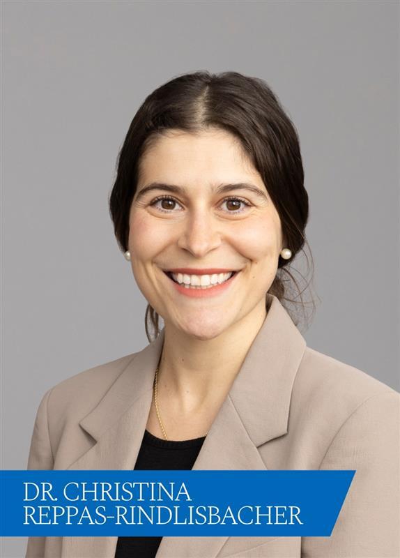 smiling woman in beige blazer