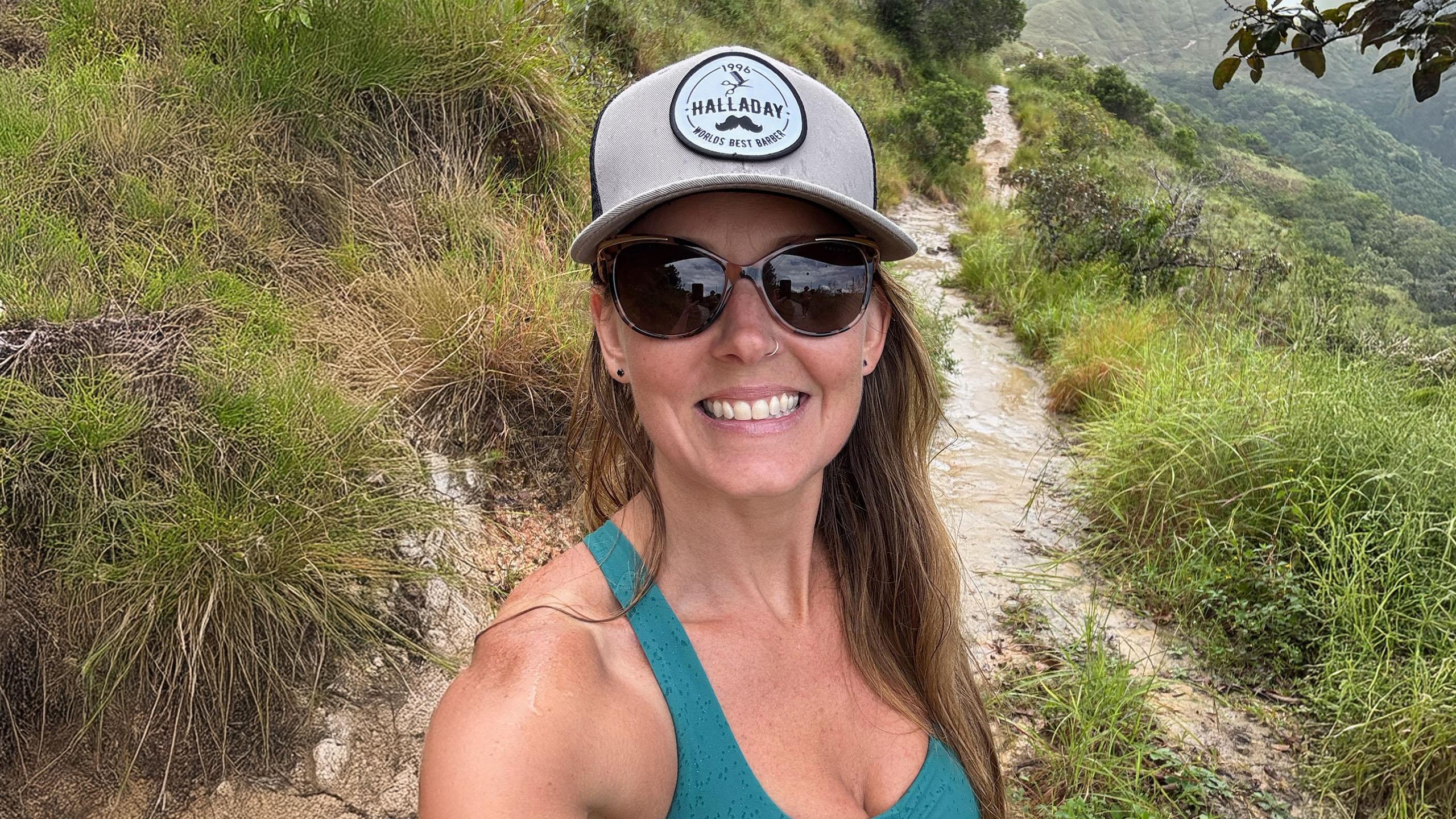Woman hiking outside, wearing sunglasses