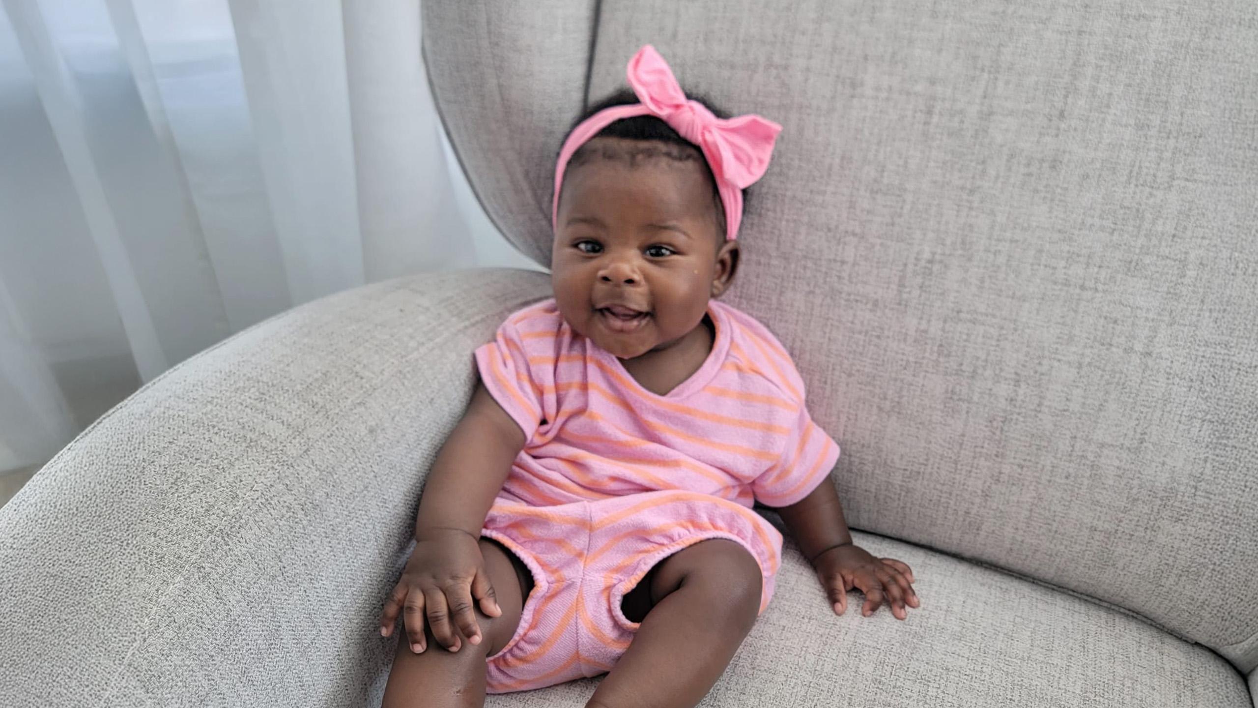 child wearing pink bow and onesie