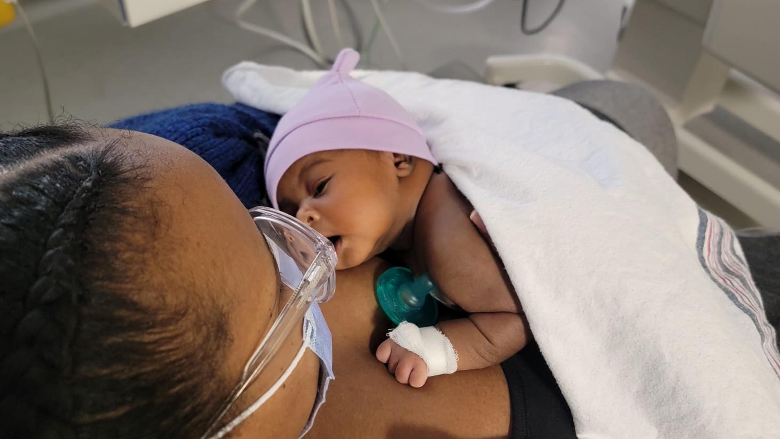 small baby lays on her mother's chest