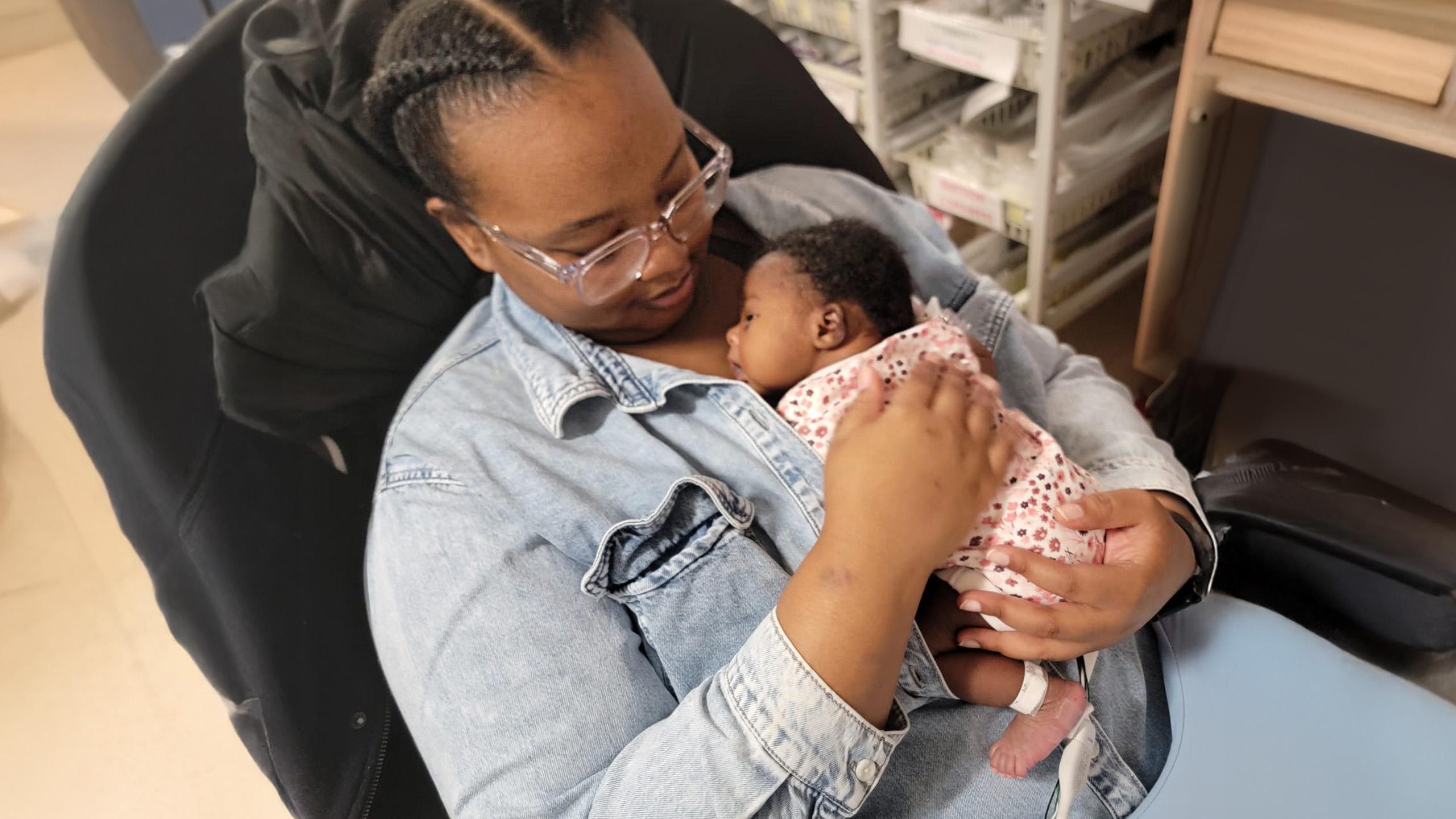 mother holds tiny baby against her chest