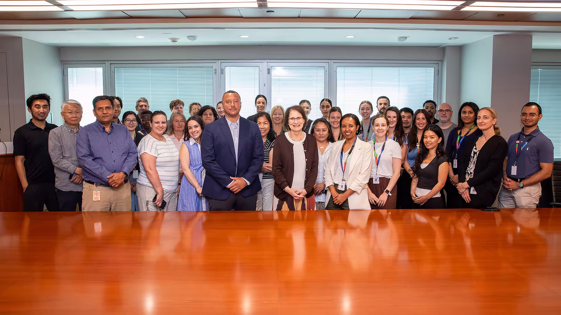 Members of the Diagnostics Medical Genetics team standing in a boardroom at Mount Sinai Hospital.