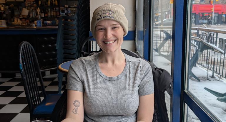 woman sits in cafe