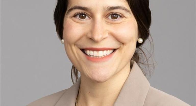 smiling woman in beige blazer