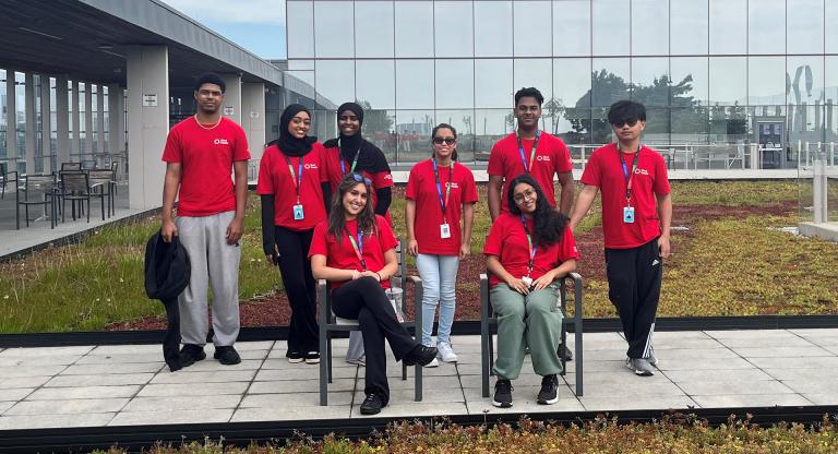 Toronto Community Housing co-op volunteers pose on the rooftop garden at Hennick Bridgepoint Hospital.
