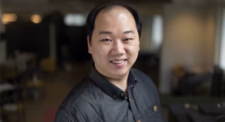 headshot of a man wearing a black shirt