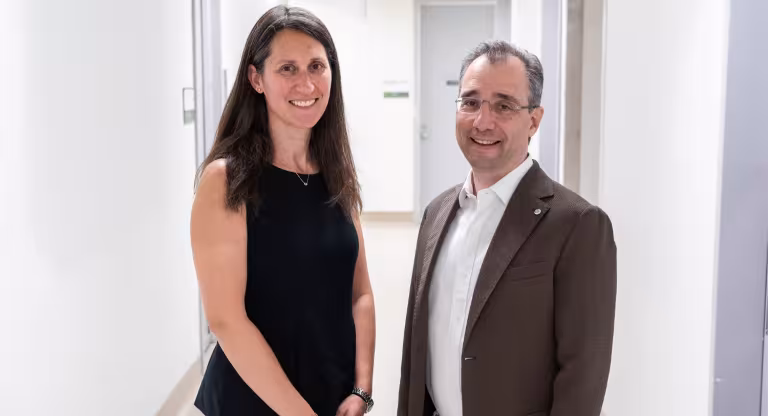Two leads of Sinai Health's Mental Health and Addictions Program stand in a hallway at Mount Sinai Hospital