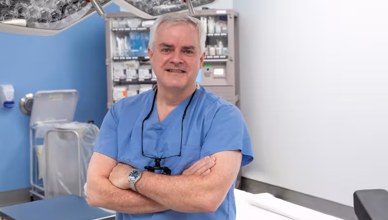 A photo of Dr. Ian Witterick, Sinai Health's surgeon-in-chief in a medical setting with this arms crossed 
