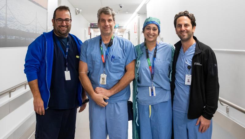 Physicians in blue scrubs in the operating room