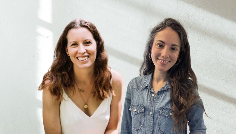 two smiling women, white background