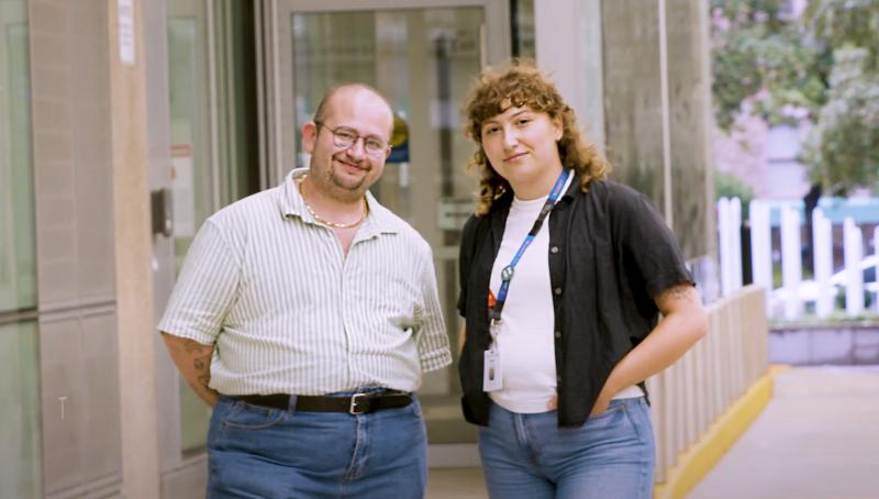 two people standing outside