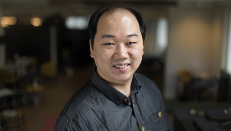 headshot of a man wearing a black shirt